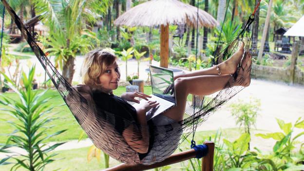 Working hard from a hammock in Indonesia (Credit: Credit: Sabrina Iovino) Working hard from a hammock in Indonesia (Credit: Credit: Sabrina Iovino)