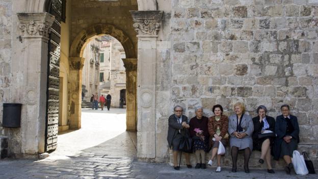 Women sitting by Dubrovnik's city walls (Credit: Credit: Santiago Urquijo/Getty) Women sitting by Dubrovnik's city walls (Credit: Credit: Santiago Urquijo/Getty)