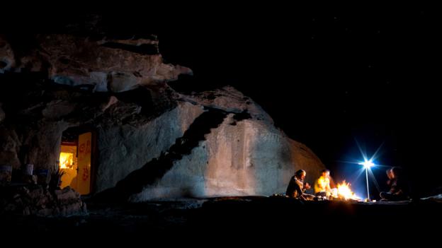 Flames flicker in the desert darkness (Credit: Credit: Will Jehring) Flames flicker in the desert darkness (Credit: Credit: Will Jehring)