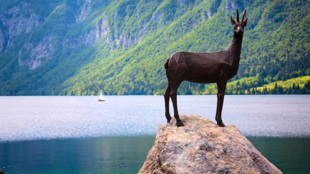 The Zlatorog, or Golden Horn, statue guards the shores of Lake Bohinj (Credit: Credit: Ken Welsh/Alamy)