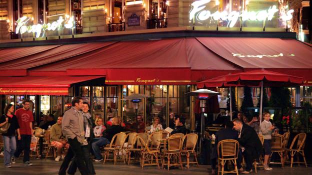 Restaurants along the Champs-Élysées (Credit: Credit: Peter Phipp/Travelshots.com/Alamy) Restaurants along the Champs-Élysées (Credit: Credit: Peter Phipp/Travelshots.com/Alamy)