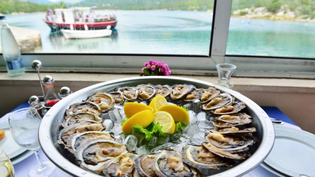 Fresh oysters are served at a waterfront restaurant in Mali Ston (Credit: Credit: Gary Blake/Alamy)