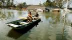 Men on a boat following Hurricane Katrina (Copyright: Getty Images)