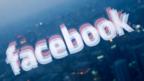 Facebook logo reflected in window (Copyright: Getty/AFP)