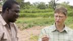 Bill Gates (right) speaks to agronomist Francis Adunoye on a visit to Nigeria in 2006