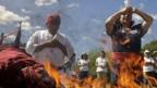 Mayan priests make offerings before a fire in San Andres, El Salvador
