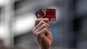 Man holds up torn credit card (Copyright: Getty images)