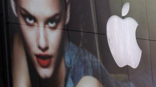 Apple logo reflected in a clothes store window (Copyright: Getty Images)