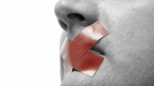 Man with tape on his mouth (Copyright: Thinkstock)