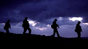 Soldiers walking in silhouette (Copyright: Getty Images)