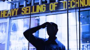 Man standing in front of news ticker (Copyright: Getty Images)