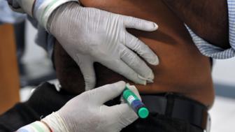 An image of a man being injected for diabetes in India