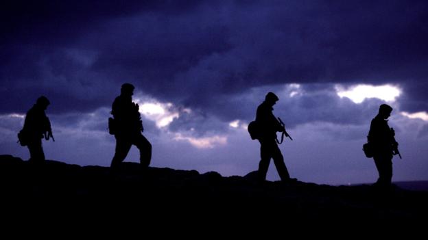 Soldiers walking in silhouette (Copyright: Getty Images)