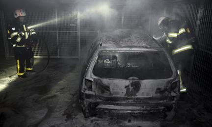 Car burned out by rioters 