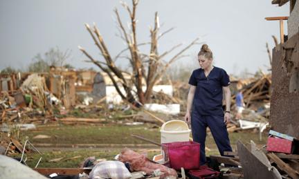 Dana Ulepich looks at the debris from her house destroyed by a powerful tornado ripped through the area on May 20, 2013 in Moore, Oklahoma. 