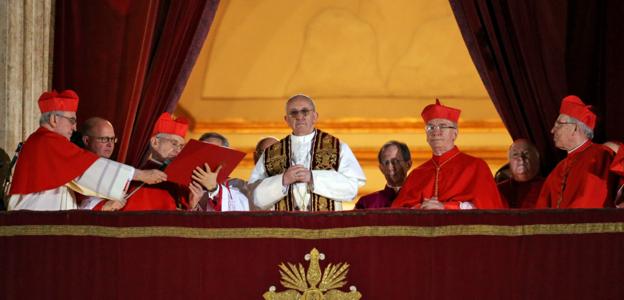 The new pope surrounded by cardinals.