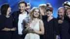 Emmelie de Forest (centre) of Denmark holds her trophy after she won the 2013 Eurovision Song Contest in Malmo on 18 May