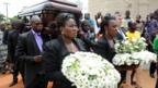 The casket containing the body of late author Chinua Achebe is carried to the funeral service in Ogidi, Nigeria on 23 May 2013