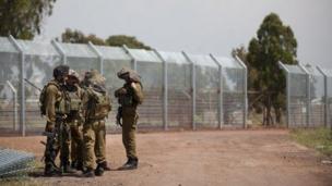 Israeli soldiers next to fence in occupied Golan Heights (file photo)