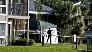 Investigators outside an apartment complex where a man was fatally shot by the FBI in Orlando, Florida, on 22 May 2013