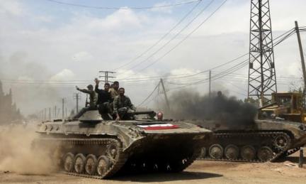 Syrian government forces celebrate as they retake village of Western Dumayna, near Qusair (13 May)