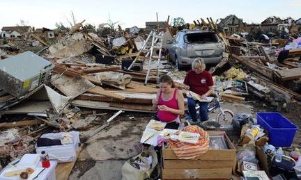 Standy Stewart (r) and her pregnant daughter-in-law Robyn Rojas have their dinner at what left of their tornado devastated home on 21 May, 2013 in Moore, Oklahoma.