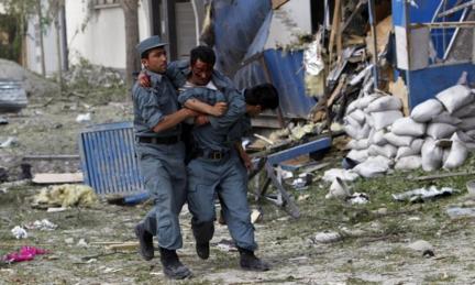 Wounded Afghan policeman being carried by colleagues in Kabul, 24 May 2013