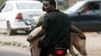 Men transport a pig with a motorbike in Kinshasa, Democratic Republic of Congo - Wednesday 28 September 2016