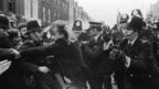 A left wing demonstrator called Robert Johnson tries to break through a police cordon