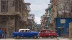 Two classic American cars cross paths in Old Havana