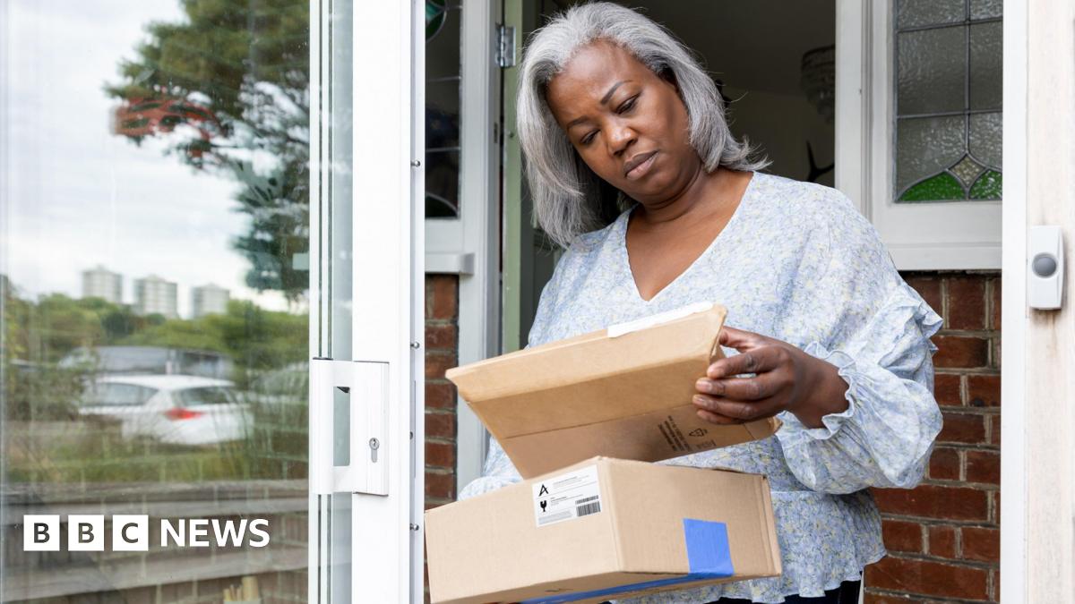 A woman receiving parcels at her front door