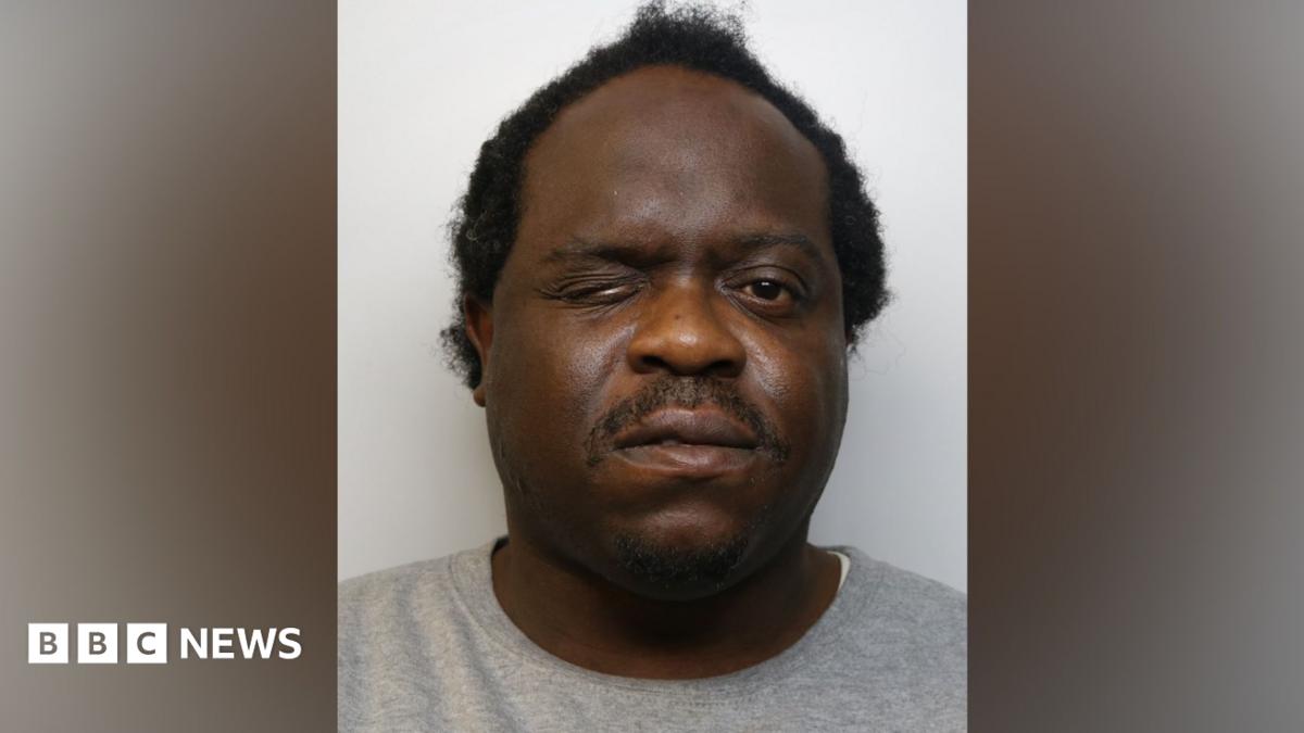 Photo: bbc.co.uk Close-up custody photograph of Levy wearing a light grey sweatshirt against a plain light-coloured background. The image is