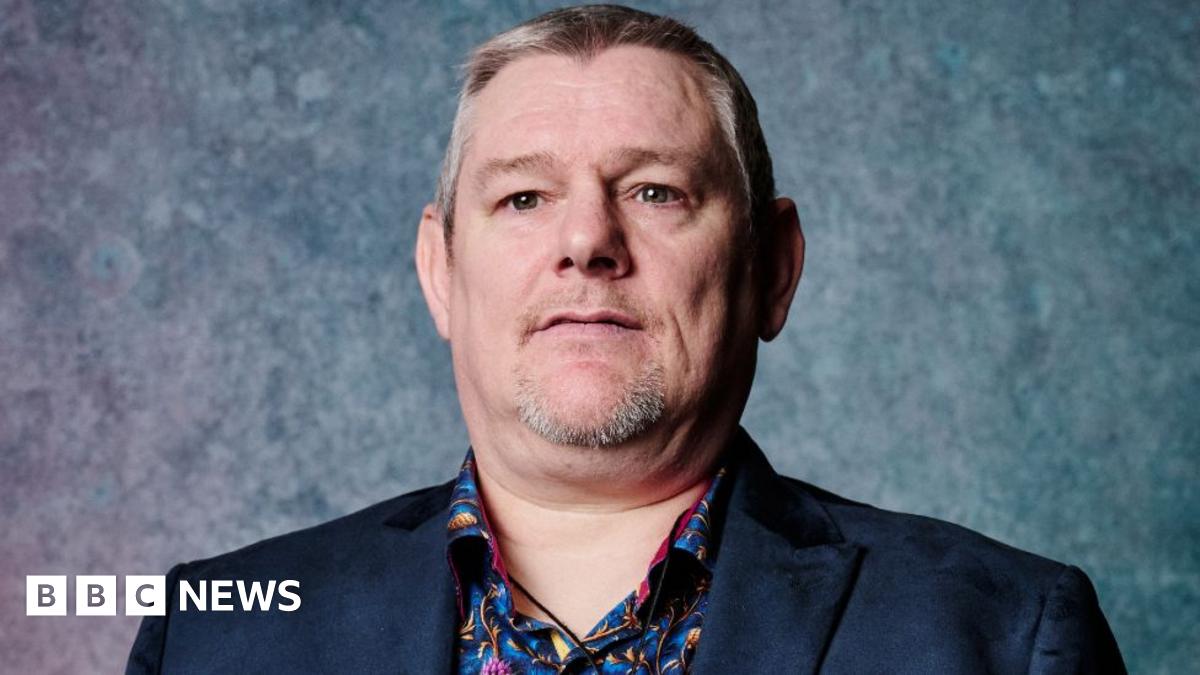 
                            John Davidson questions his proximity to a microphone at Bafta Film Awards