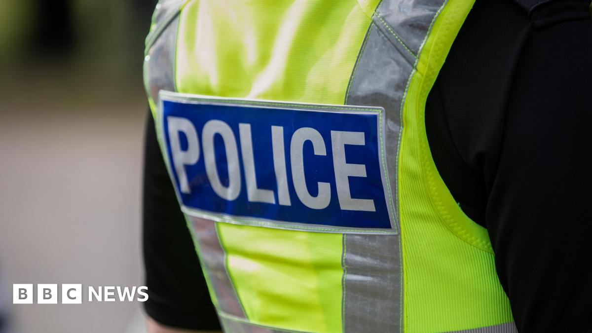 The back of a police officer's yellow hi vis