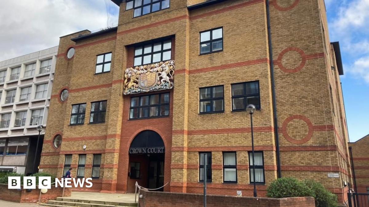 St Albans Crown Court: A yellow-and-red brick building. In front on the court building is  a small red-brick wall and three grey steps. The words "CROWN COURT" are written above the entrance.