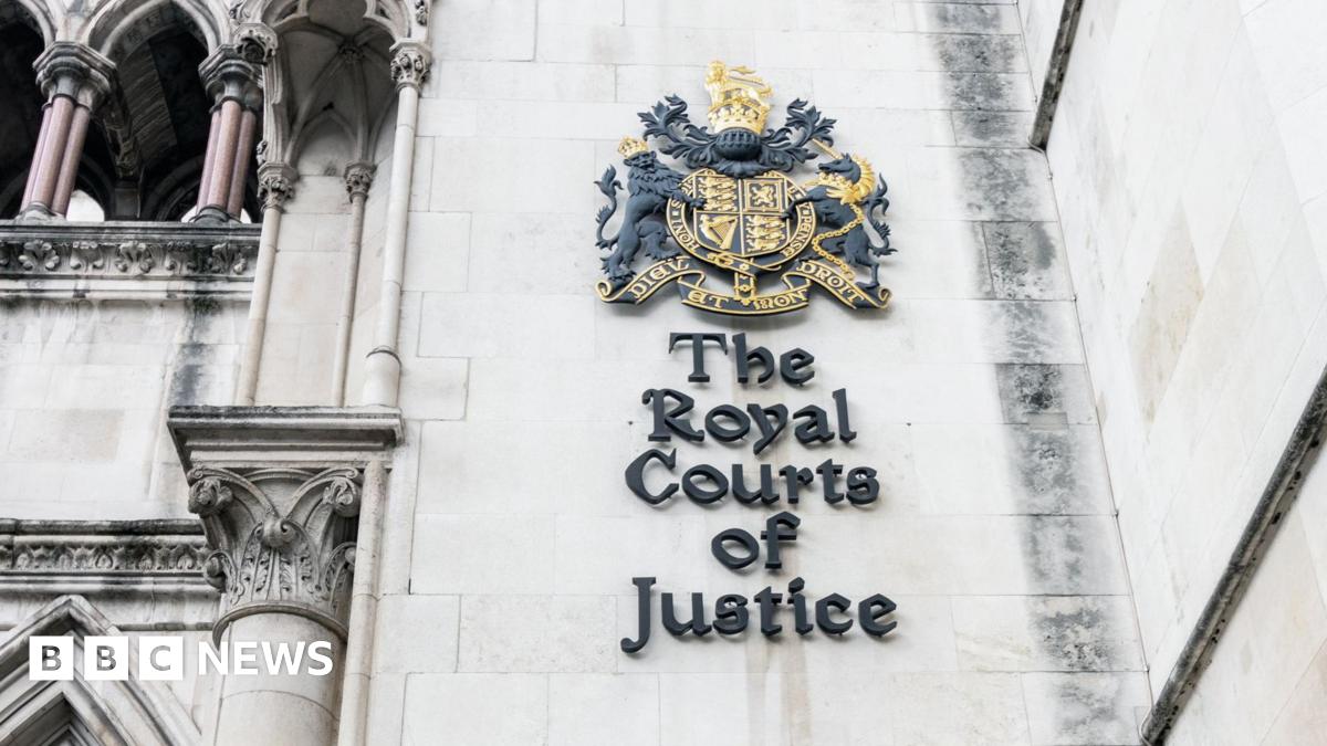Exterior close up sign on the wall of the Royal Courts of Justice in London