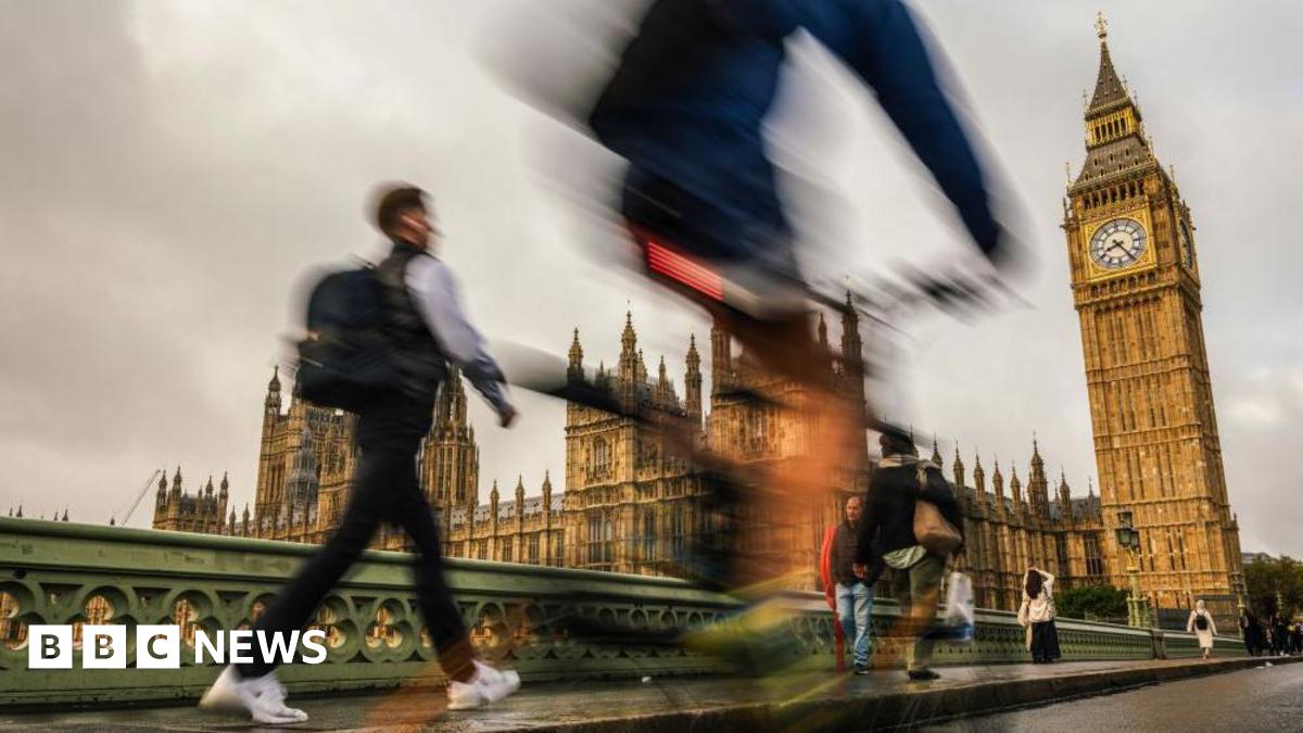 Blurred images of cyclists and pedestrians walking in front of the Houses of Parliament and Big Ben