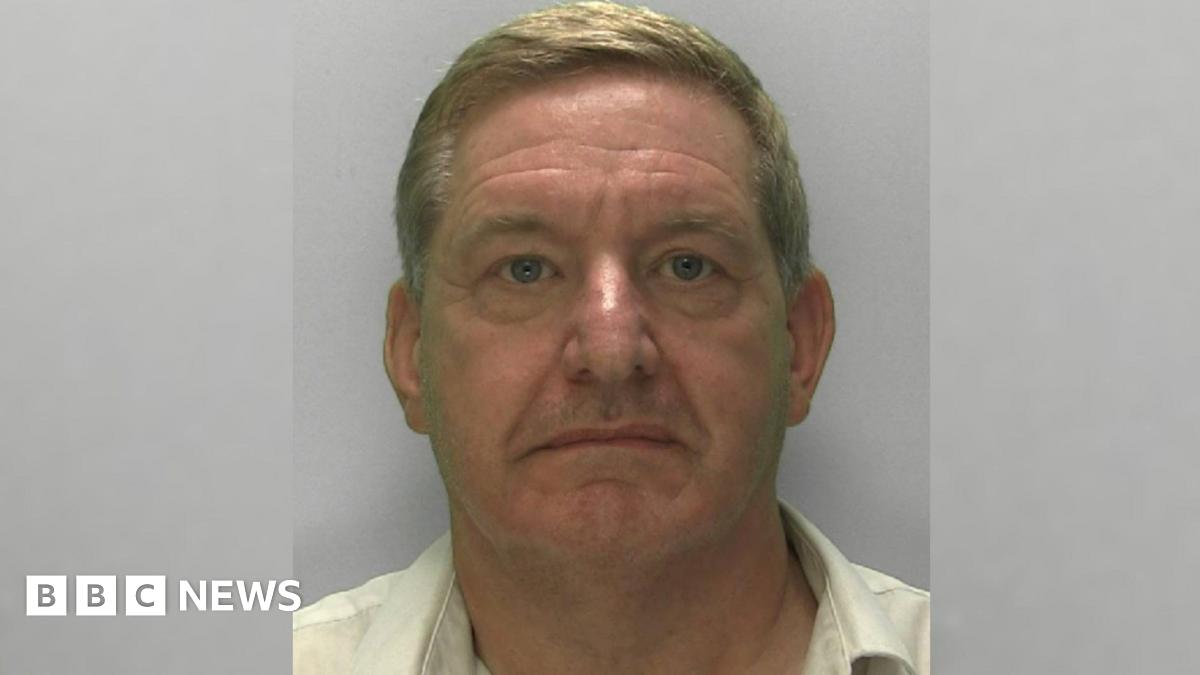 Police mugshot of offender Ashley Watson in custody wearing a pale yellow shirt and looking at the camera