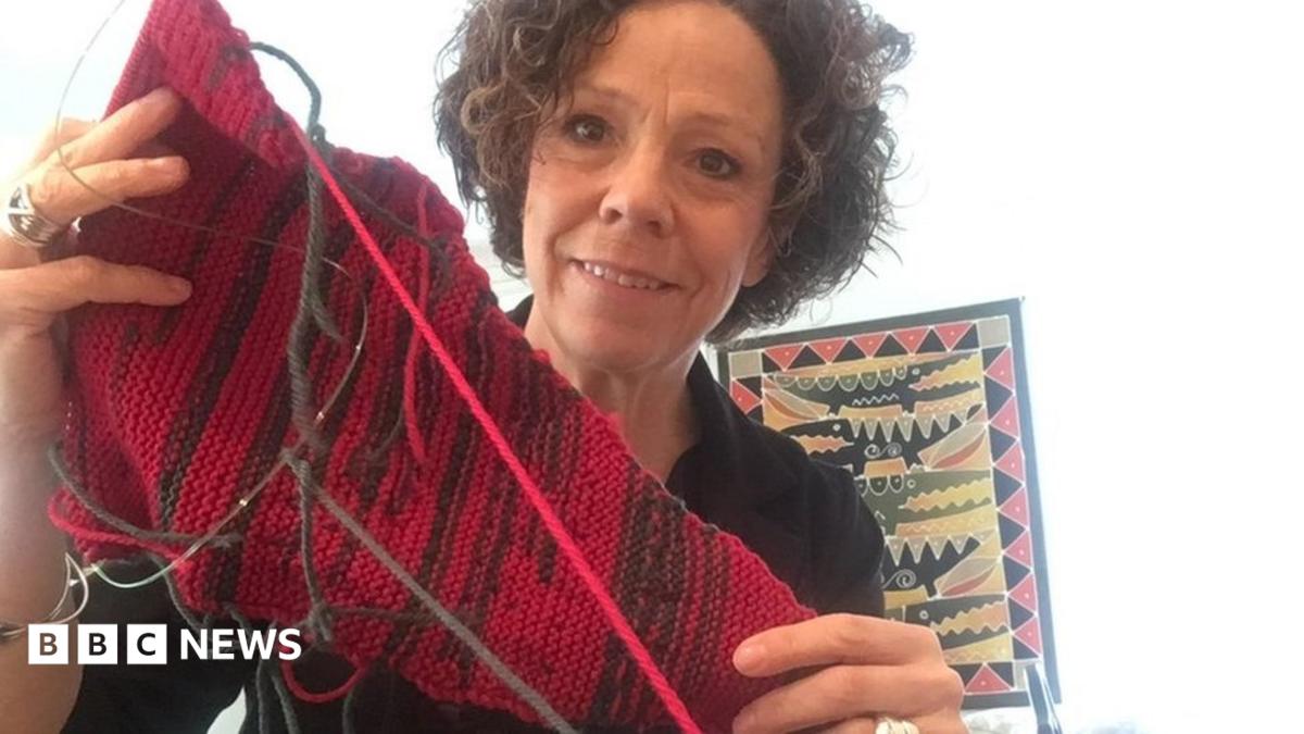 Sue Montgomery holds up her knitting