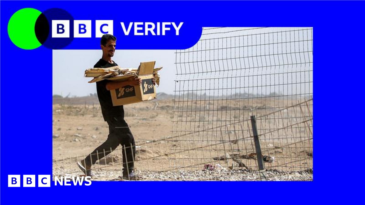 A file photo showing a man carrying a box with aid