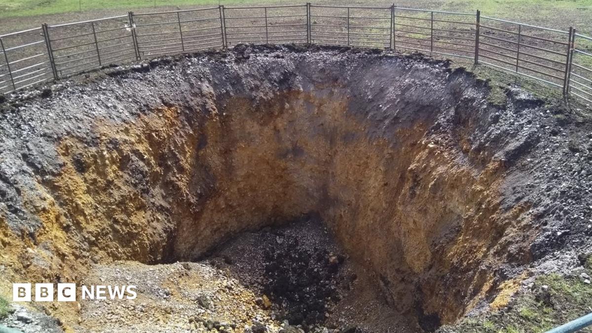 Large sink-hole opens up on Dorset coast path - BBC News