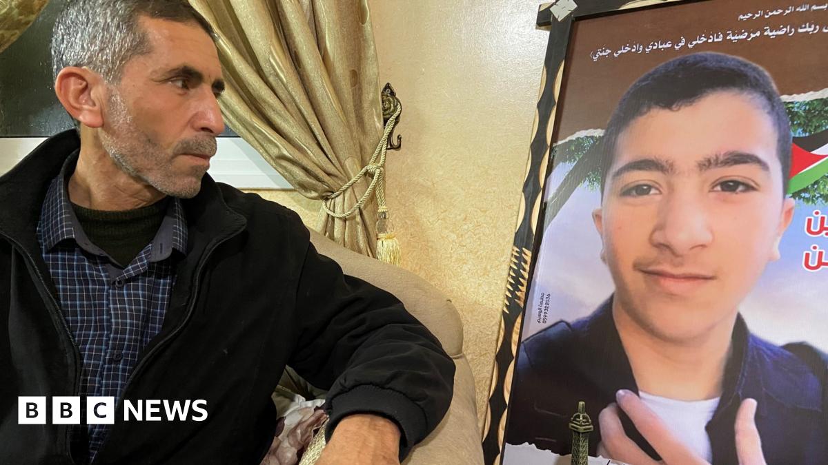 Omar al-Nawati with a portrait of his son Salem