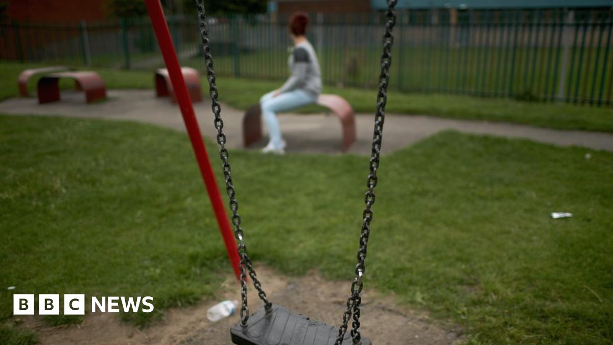 Teenage girl nears a swing