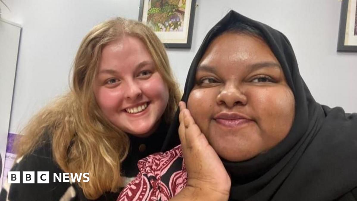 Molly Fenton and Athika Ahmed smile at the camera. Athika cups her chin with one hand.