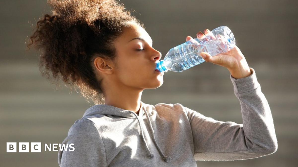 Woman drinking from a water bottle