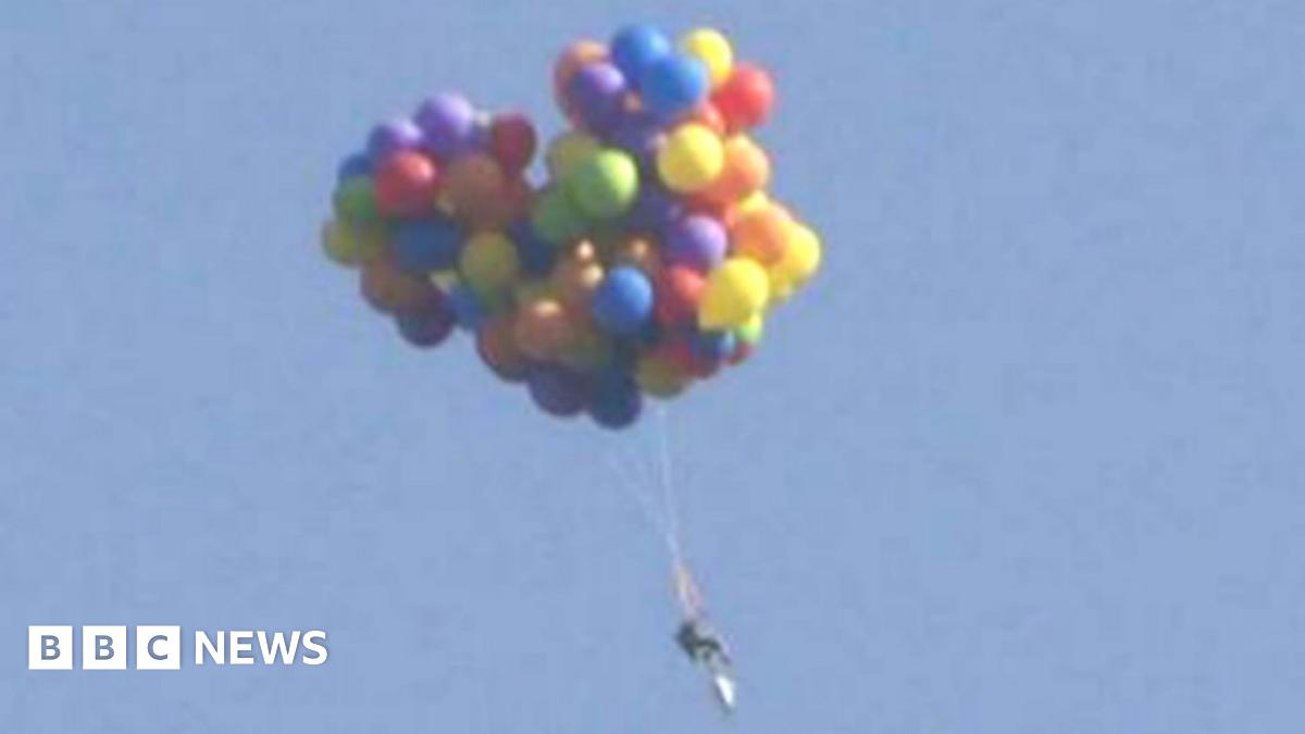 Canadian flew over Calgary in chair carried by balloons BBC News(02)