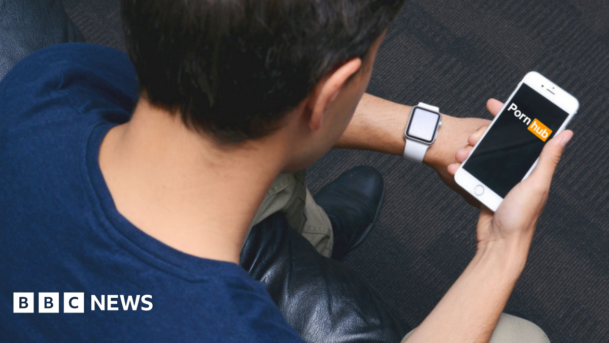 Man on smartphone with pornhub logo