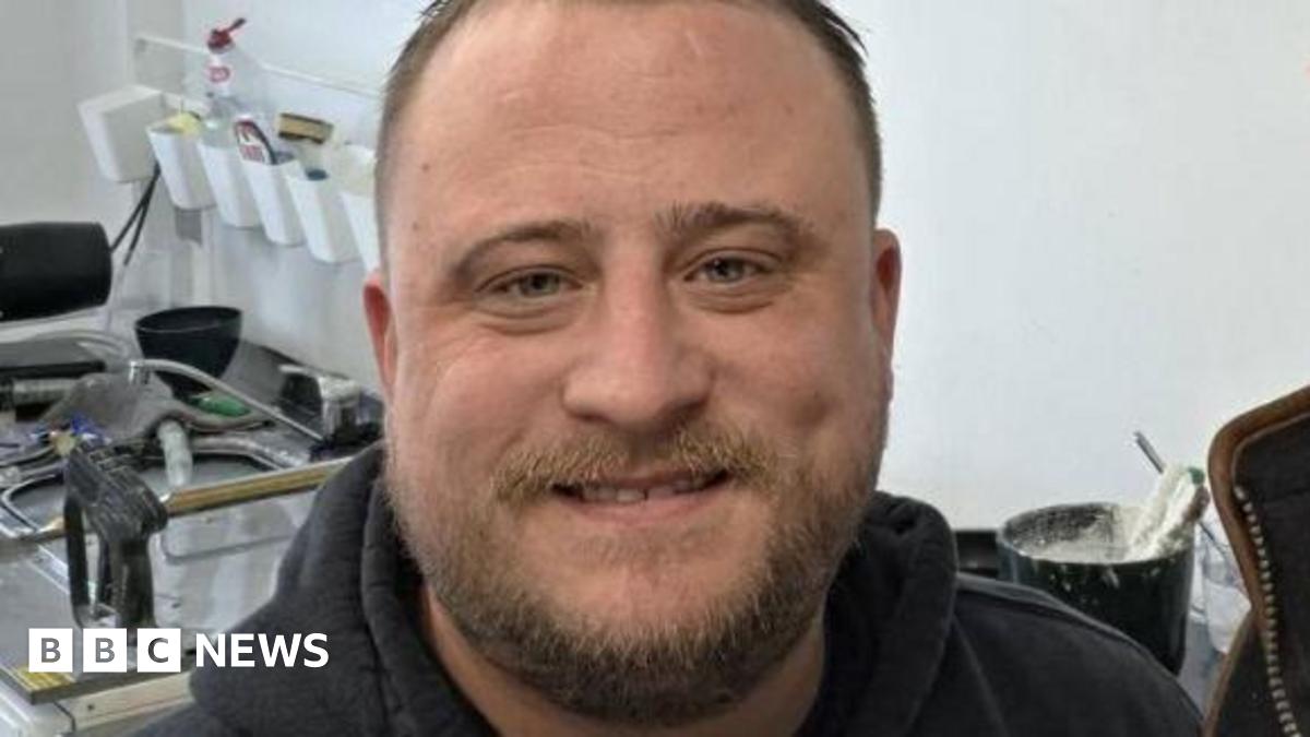 A close up of a selfie of Martin Roberts stood next to someone else who is out of shot. He is stood in front of a collection of medical equipment.