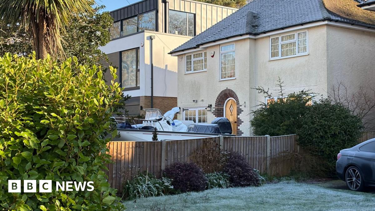 Forensic police officers search a boat and a car on the driveway of a property in Anthony's Avenue, Poole, Dorset where an elderly couple in their 70's, named locally as Heather and Michael Newton, were found dead on 31 December.