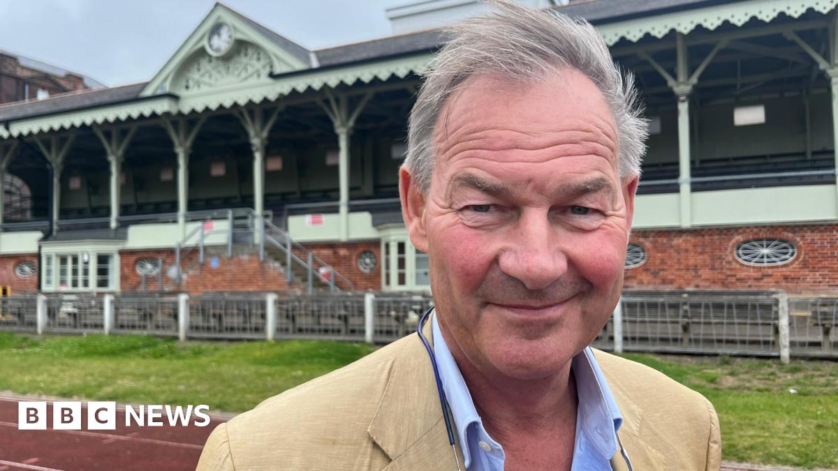 Rupert Lowe looks to camera wearing a tan suit after his election victory in July 2024